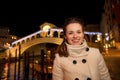 Happy woman standing in front of Rialto Bridge in Venice, Italy Royalty Free Stock Photo