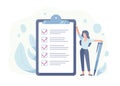 Happy woman standing beside giant check list and holding pen. Concept of successful completion of tasks, effective daily Royalty Free Stock Photo