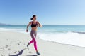 Happy woman standing with her arms wide open at the beach Royalty Free Stock Photo