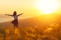 Happy woman standing with her back on sunset in nature iwith ope Royalty Free Stock Photo