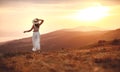 Happy woman standing with her back on sunset in nature iwith open hands Royalty Free Stock Photo