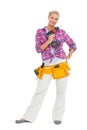 Happy woman standing holding a drill Royalty Free Stock Photo