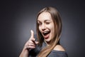 Happy Woman Sticking Out Her Tongue Over Grey Royalty Free Stock Photo