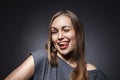 Happy Woman Sticking Out Her Tongue Over Grey Royalty Free Stock Photo