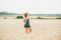 Happy woman with straw hat in hands enjoying sun on cereal field Royalty Free Stock Photo