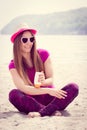 Happy woman in straw hat and sunglasses using sun lotion, sun protection on beach Royalty Free Stock Photo