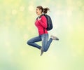 Happy woman or student with backpack jumping Royalty Free Stock Photo