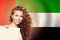 Happy woman student with white banner on the UAE flag background. United Arab Emirates, travel and learn arabic language concept