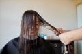 Happy woman with stylist cutting hair at salon Royalty Free Stock Photo