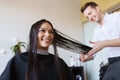 Happy woman with stylist cutting hair at salon Royalty Free Stock Photo