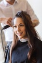 Happy woman with stylist making hairdo at salon Royalty Free Stock Photo