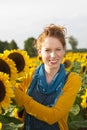 Happy Woman in a sunflower field Royalty Free Stock Photo