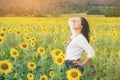 Happy woman in sunflower field smiling with happiness Royalty Free Stock Photo