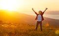 Happy woman on sunset in nature iwith open hands Royalty Free Stock Photo
