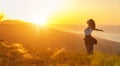 Happy woman on sunset in nature iwith open hands Royalty Free Stock Photo