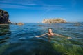 Happy woman swimming in the sea of an idyllic beach Royalty Free Stock Photo
