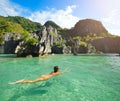 Happy woman swims in the crystal clear water near of islands Royalty Free Stock Photo