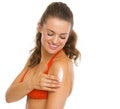 Happy woman in swimsuit applying sun block creme Royalty Free Stock Photo