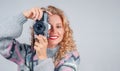 Cute woman taking a photo with a camera on a white background Royalty Free Stock Photo