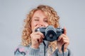 Cute woman taking a photo with a camera on a white background Royalty Free Stock Photo