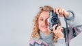 Cute woman taking a photo with a camera on a white background Royalty Free Stock Photo