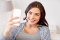 Happy woman taking selfie with smartphone at home Royalty Free Stock Photo