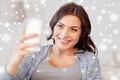 Happy woman taking selfie with smartphone at home Royalty Free Stock Photo