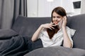 happy woman talking on the phone at home on sofa interior gray curtains Royalty Free Stock Photo