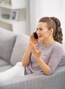 Happy woman talking phone in living room Royalty Free Stock Photo