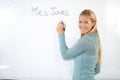 Happy woman, teacher portrait or writing on whiteboard for education, learning or teaching. Smile of a young professor Royalty Free Stock Photo