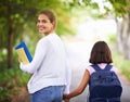 Happy woman, teacher and walking student to school in park or outdoor forest for support or responsibility. Female Royalty Free Stock Photo