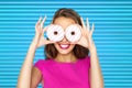 Happy woman or teen girl looking through donuts Royalty Free Stock Photo