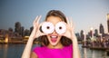 Happy woman or teen girl looking through donuts Royalty Free Stock Photo