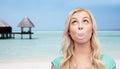 Happy woman or teenage girl chewing gum on beach Royalty Free Stock Photo