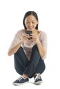 Happy Woman Text Messaging Through Mobile Phone