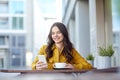 Happy woman texting on smartphone at city cafe Royalty Free Stock Photo