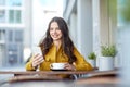 Happy woman texting on smartphone at city cafe Royalty Free Stock Photo