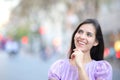 Happy woman thinking looking at side in the street Royalty Free Stock Photo