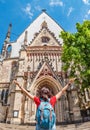 Woman tourist admires Panoramic view of Architecture and Facade of St. Thomas Church Thomaskirche in Leipzig, Germany Royalty Free Stock Photo