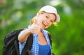 Happy woman tourist with a backpack shows thumb up Royalty Free Stock Photo