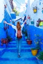 Happy woman tourist in the blue street of Chefchaouen Royalty Free Stock Photo