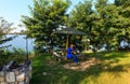 Happy woman on camping pitch on summer lake calm beach Royalty Free Stock Photo