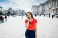 Happy woman tourist in front of Cathedral Santa Maria la Real de La Almudena in Madrid,Spain.Tourist using vacation sim card Royalty Free Stock Photo