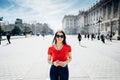 Happy woman tourist in front of Cathedral Santa Maria la Real de La Almudena in Madrid,Spain.Tourist using vacation sim card Royalty Free Stock Photo