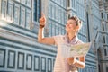 Happy woman tourist with map pointing on something near Duomo Royalty Free Stock Photo