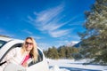 Happy woman travel by car in winter Royalty Free Stock Photo