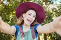 Happy, woman and travel for nature selfie excited on summer vacation enjoying the countryside in the outdoors. Portrait