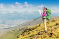 Woman traveler with a backpack and a map on the background of the Pyrenees mountains. Hiking and adventure concept Royalty Free Stock Photo