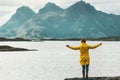 Happy Woman Traveler hands raised enjoying Norway mountains and sea landscape Travel Lifestyle Royalty Free Stock Photo