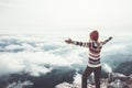 Happy woman traveler on mountain summit hands raised Royalty Free Stock Photo